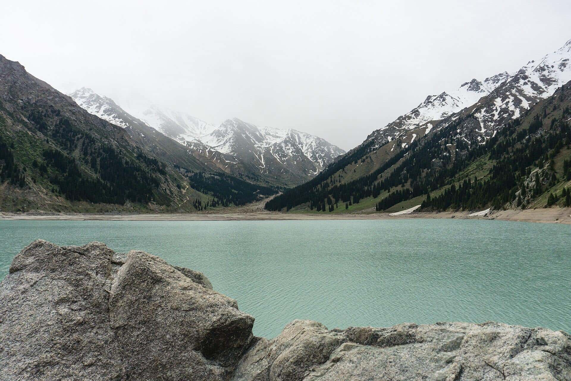 Big Almaty Lake in May: turquoise water and snowy Trans-Ili Alatau peaks — mountain lakes near Almaty