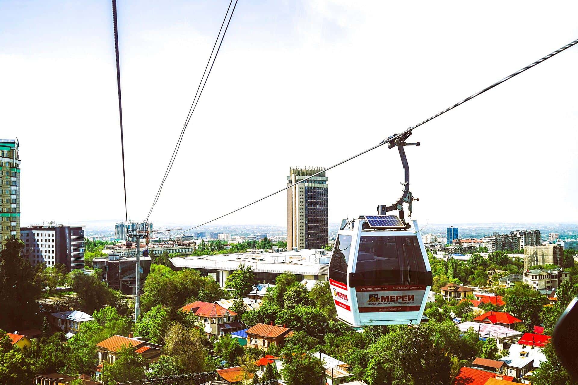 Kok-Tobe cable car cabin above the rooftops of Almaty — a day out with kids