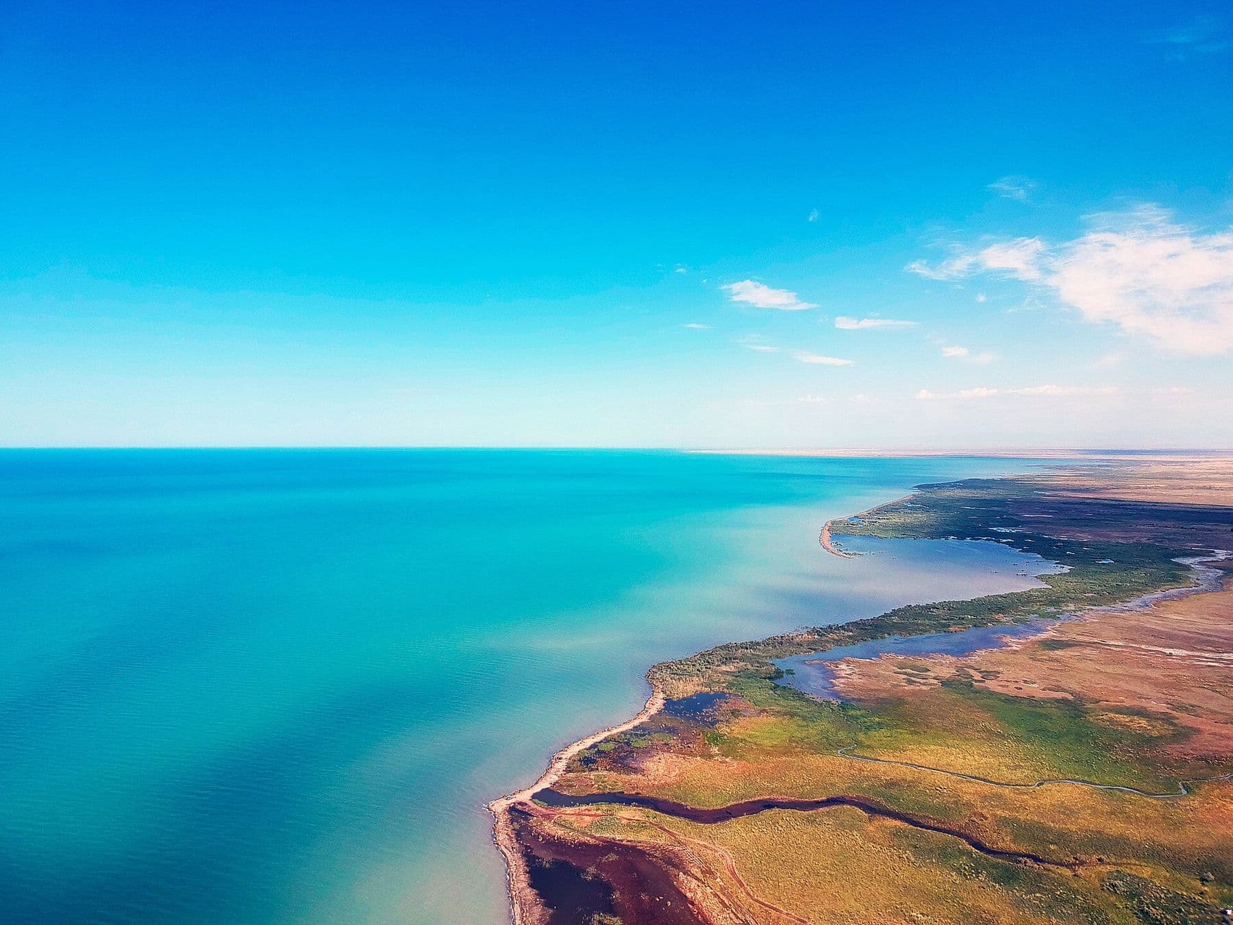 Turquoise water and sandy spits of Lake Alakol from above — a lake for a long weekend with an overnight stay