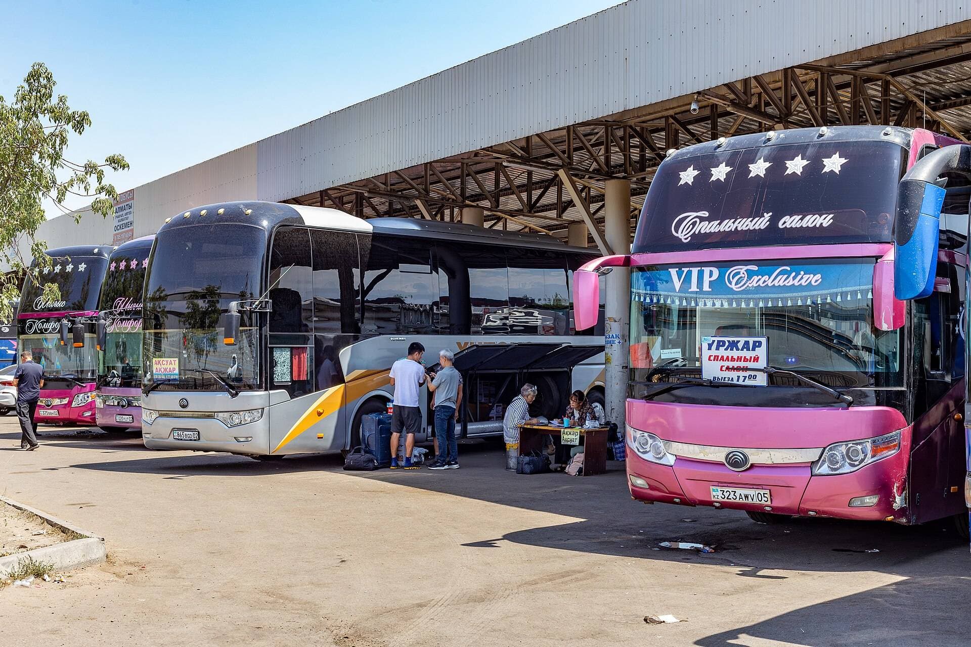 Large intercity coaches at Salem bus station in Almaty — for 27+ people; up to 13 fit in a minibus