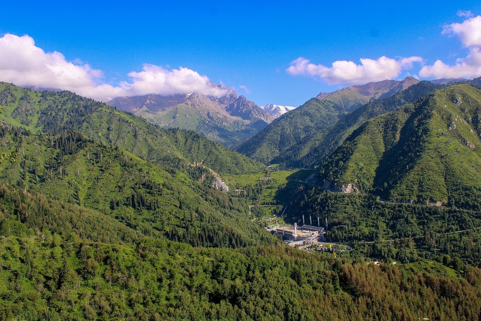 Malaya Almatinka gorge in summer with the Medeu rink below — the closest day trips from Almaty
